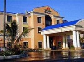 cream colored 3 story building with blue roof holiday inn express